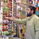 A shopkeeper displaying bangles in a local market to attract the customers in connection with upcoming Eidul Fitr