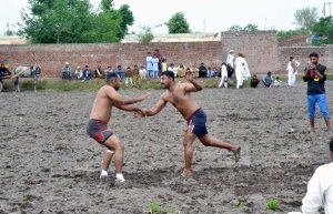 Players in action during a kabaddi match at Chak No. 13 Kalro in Chiniot