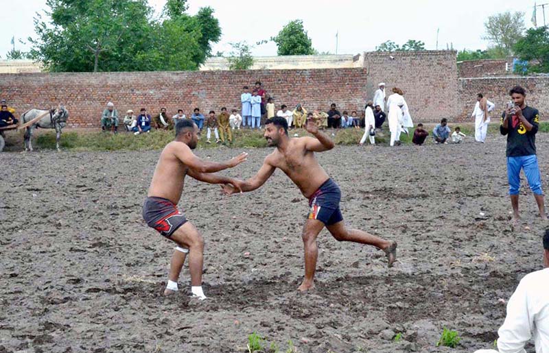 Players in action during a kabaddi match at Chak No. 13 Kalro in Chiniot