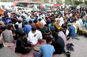 People break their fast during Free Iftar at the roadside in the city during the holy fasting month of Ramazan.