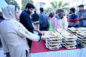 Member of Punjab Assembly Hina Arshad Warraich distributing Iftar food among the public at Government Allama Iqbal Teaching Hospital during her visit.