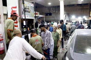 A large number of people in long queue to get gasoline as per expected shortage in the city due to war crisis in the Gulf region.