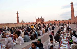 Faithful wait for the Maghrib Azaan to break their fast on the last day of Ramazan at Badshahi Masjid in the provincial capital