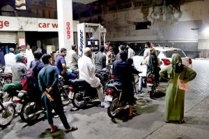 A large number of people in long queue to get gasoline as per expected shortage in the city due to war crisis in the Gulf region.