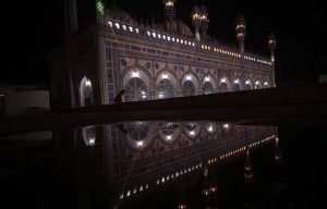 A beautiful view of Qadeemi Jamia Masjid reflected in water during the night of Lailatul Qadr in the holy month of Ramazan.