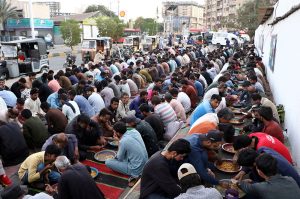 A large number of people break their fast during Free Iftar at the roadside in the city during the holy fasting month of Ramazan