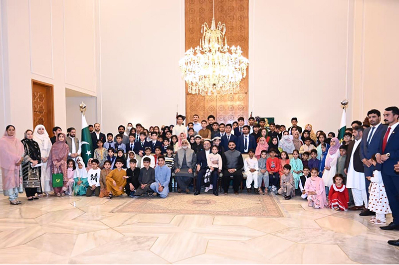 President Asif Ali Zardari poses for a group photograph with orphan children during an Iftar dinner hosted at Aiwan-e-Sadr in connection with the observance of Orphans Day