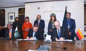 Secretary Economic Affairs Division, Muhammad Humair Karim and Sebastian Jacobi, Country Director of the German Government Bank for Development (KfW), signing a grant agreement. APP/ABB