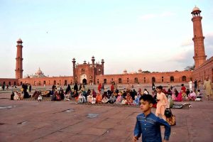 Faithful wait for the Maghrib Azaan to break their fast on the last day of Ramazan at Badshahi Masjid in the provincial capital