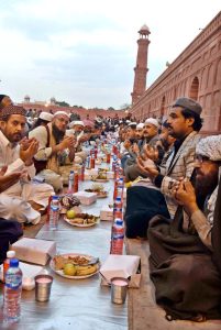 Faithful offering dua while waiting for the Maghrib Azaan to break their fast on the last day of Ramazan at Badshahi Masjid in the provincial capital