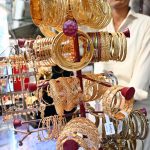 A vendor displaying bangles to attract the customers in connection with upcoming Eidul Fitr at Resham Gali