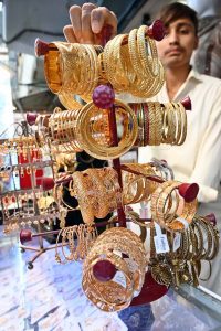 A vendor displaying bangles to attract the customers in connection with upcoming Eidul Fitr at Resham Gali