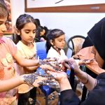 Young girls are decorating their hands with henna (Mehndi) in preparation for Eid-ul-Fitr at the Press Club