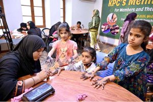 Young girls are decorating their hands with henna (Mehndi) in preparation for Eid-ul-Fitr at the Press Club