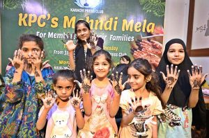 Young girls are decorating their hands with henna (Mehndi) in preparation for Eid-ul-Fitr at the Press Club