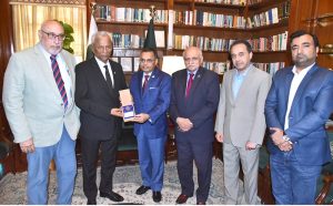 Muhammad Saeed Sheikh, President of the Houston-Karachi Sister City Association, presents the gift on behalf of the Mayor of Houston to Sindh Governor, Muhammad Nehal Hashmi at Governor House