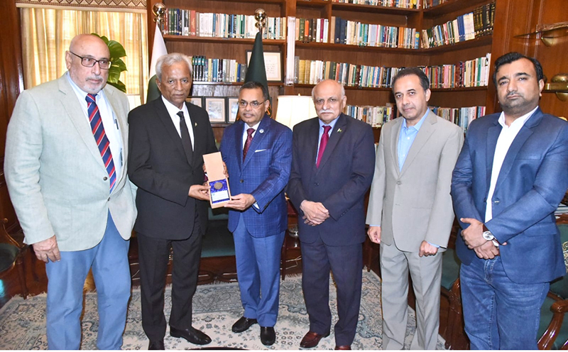 Muhammad Saeed Sheikh, President of the Houston-Karachi Sister City Association, presents the gift on behalf of the Mayor of Houston to Sindh Governor, Muhammad Nehal Hashmi at Governor House