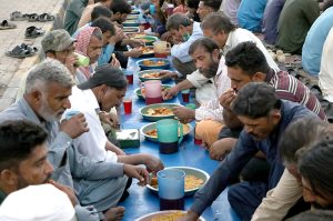 A large number of people break their fast during Free Iftar at the roadside in the Saddar area of the city during the holy fasting month of Ramazan.