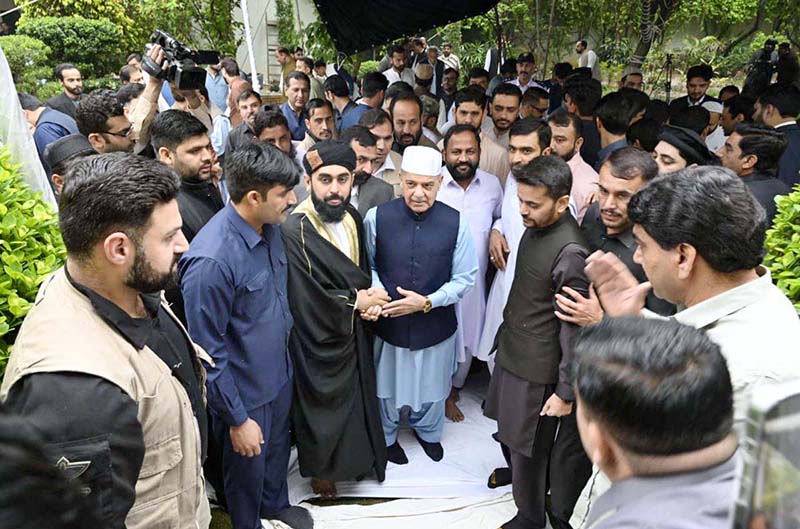 Prime Minister Muhammad Shehbaz Sharif exchanging Eid greetings with people after offering Eid ul Fitr prayers
