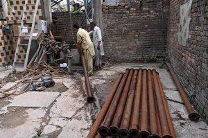 WASA workers busy repairing a local tube well at Pindora Benazir Chowk near Saidpur Road