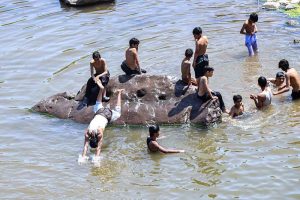 Youngsters are jumping and bathing in the Rawal Dam adjacent nallah as the mercury increases day by day in the Federal Capital