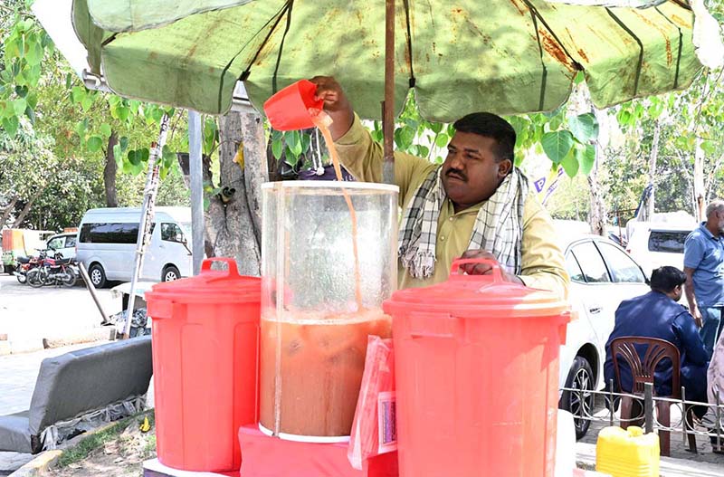 A vendor selling traditional summer drink at his roadside setup in the Provincial Capital