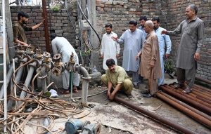 WASA workers busy repairing a local tube well at Pindora Benazir Chowk near Saidpur Road