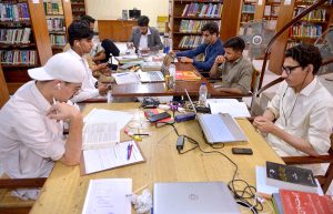 Students take notes from e-books on tablets in the lounge of Shuhada-e-APS Public Library ahead of World Book Day.