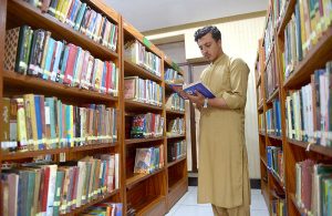 Students take notes from e-books on tablets in the lounge of Shuhada-e-APS Public Library ahead of World Book Day.