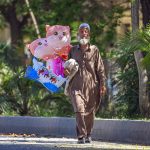 An elderly vendor displayed different cartoon shape balloons to attract the customers at Park Road in the Federal Capital