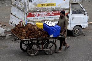 A view of a vehicle making its way through accumulated rainwater as showers hit the city
