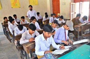 A girl student attempts her paper during the annual SSC (Part-I) Class 9 examinations at Government APWA Girls High School, Latifabad.