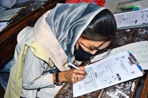 A girl student attempts her paper during the annual SSC (Part-I) Class 9 examinations at Government APWA Girls High School, Latifabad.