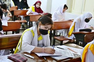 Students solving question paper during annual examination of Intermediate HSC (Part-II) at Nazareth Girls College.