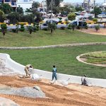 Laborers busy in beautification work at Koral Chowk Interchange on the Expressway in the Federal Capital