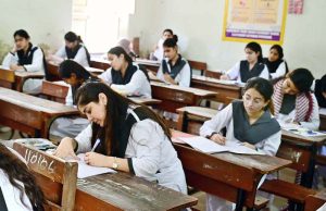 Students solving question paper during annual examination of Intermediate HSC (Part-II) at Nazareth Girls College.