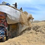 Labourers are busy unloading the chaff (husk from wheat) from delivery truck at Tarlai