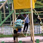 Children enjoy swings at a local park along Faisal Avenue in the Federal Capital