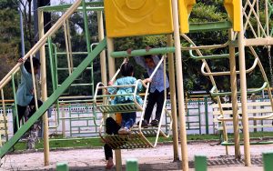 Children enjoy swings at a local park along Faisal Avenue in the Federal Capital