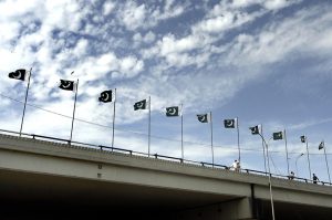 The national flag flutter atop on a bridge near Zero Point in the federal capital ahead of the second round of upcoming peace talks.