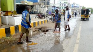 WASA workers drain rainwater accumulated on city roads following overnight showers, restoring normal traffic flow.
