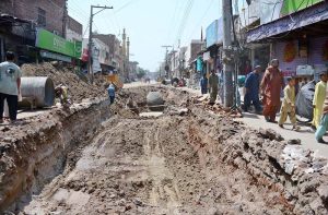 A view of sewerage pipeline laying work along Delhi Gate Road, where large trenches are dug for laying underground pipelines, causes disruption to traffic flow and daily life.