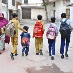 School children are on the way to school with their bags as classes resume after vacations
