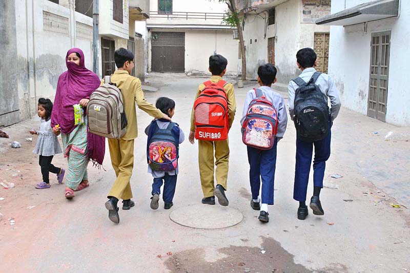 School children are on the way to school with their bags as classes resume after vacations