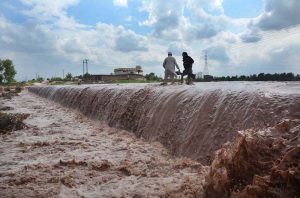 Residents take the risk of wading through rising and dangerous floodwaters at Tapu Barra Pull following heavy rains that inundated the area.