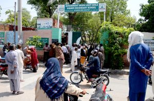 Parents gather outside Govt. Moon Light Higher Secondary Girls School to pick up their daughters after the 9th class examination, causing a rush at the main gate.