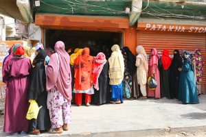 Women in queue outside a mobile communication shop in Latifabad to receive cash assistance under the Benazir Income Support Program (BISP).