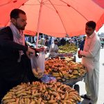 A vendor selling banana to attract customers at his roadside setup