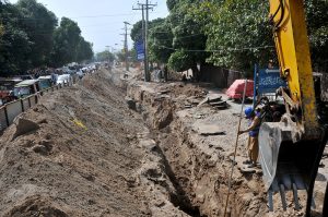 Workers continue sewerage pipeline installation in front of Nishtar Hospital to improve the city’s drainage system.