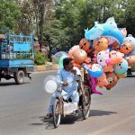 A disable vendor on the way on wheelchair displayed air filled toys to attract the customers
